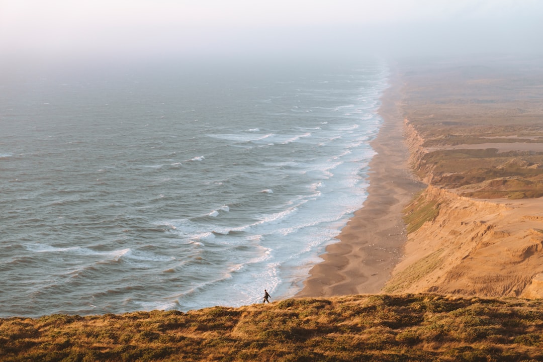 man walking near cliff