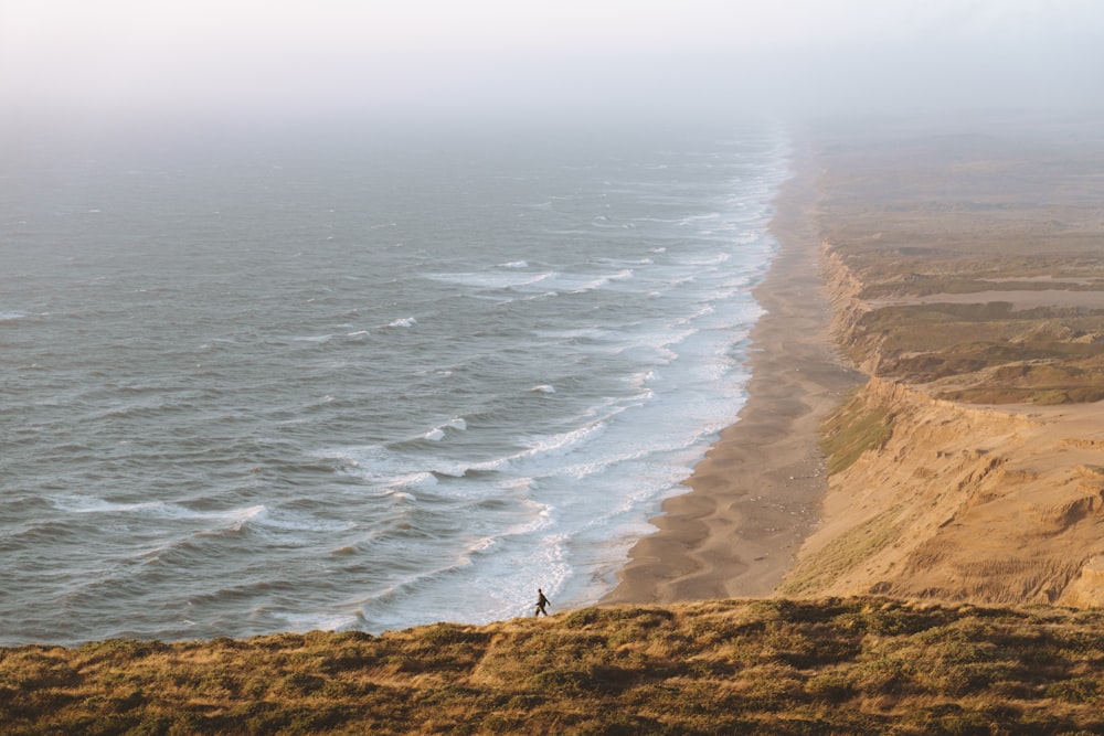 man walking near cliff