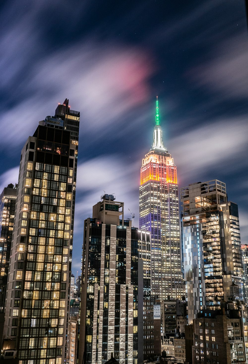 time lapse photography of well lighted buildings at night