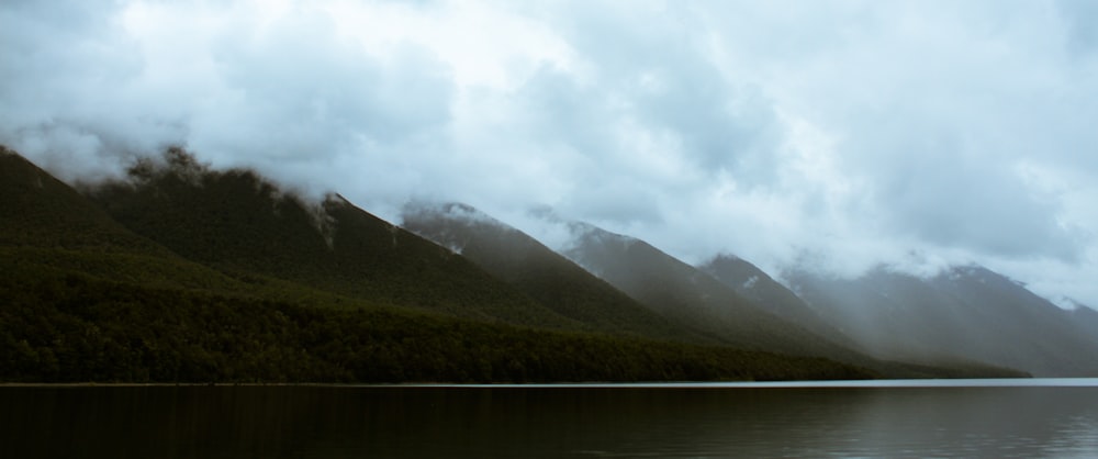 body of water near mountains