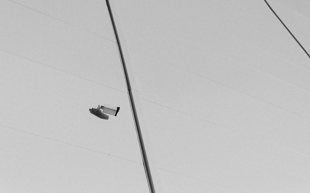 a street light on a pole with power lines in the background