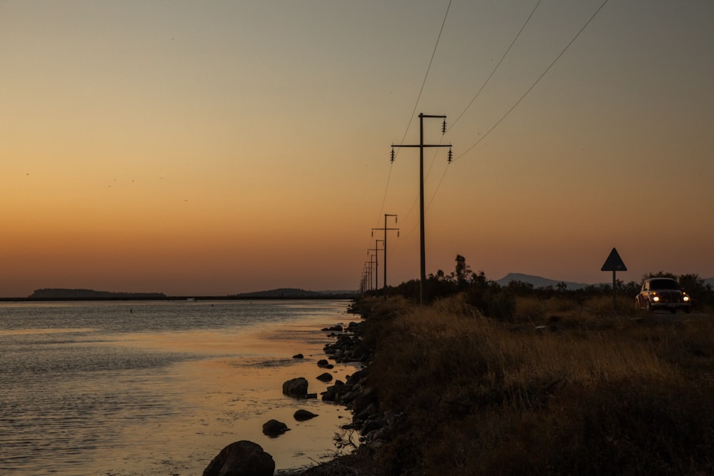 cable towers beside body of water