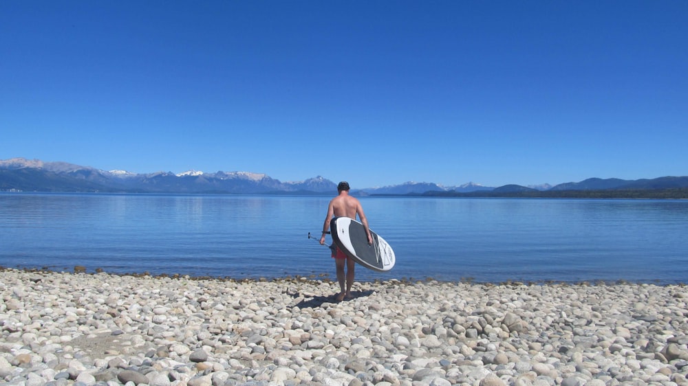 man holding surfboard