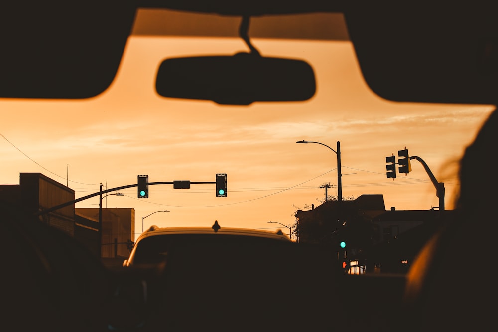 a view of a traffic light from inside a car