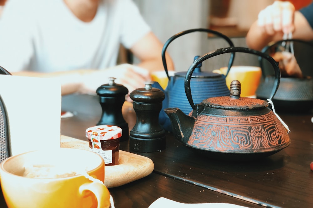 two teapots on table top