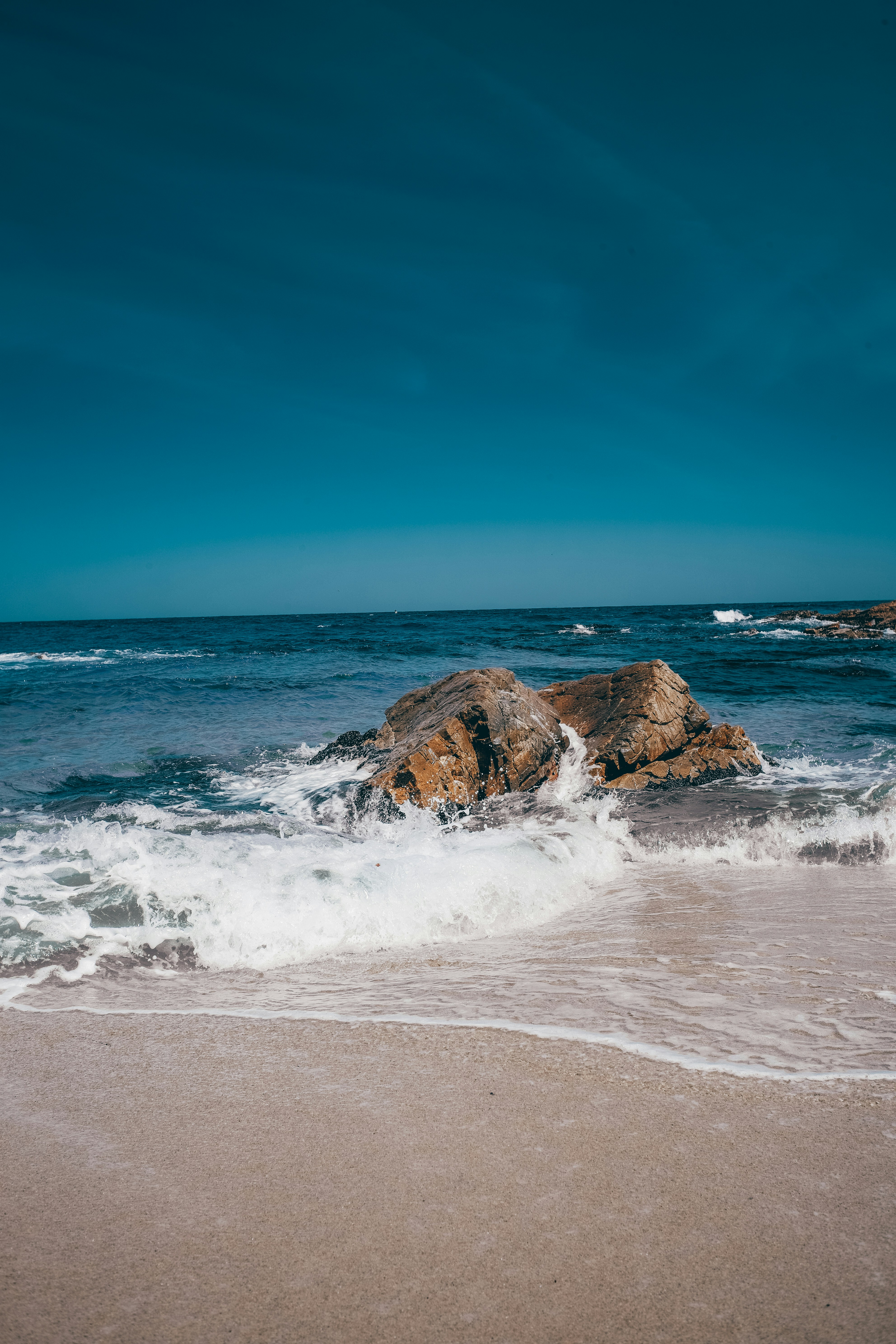 a large rock in the middle of a body of water