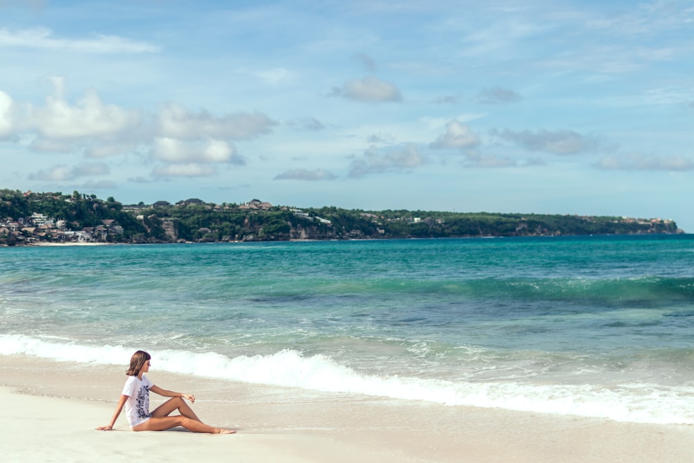 woman sitting on shore