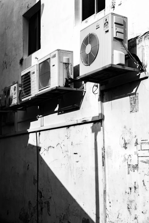 Black and white photo of rooftop condenser units in a row