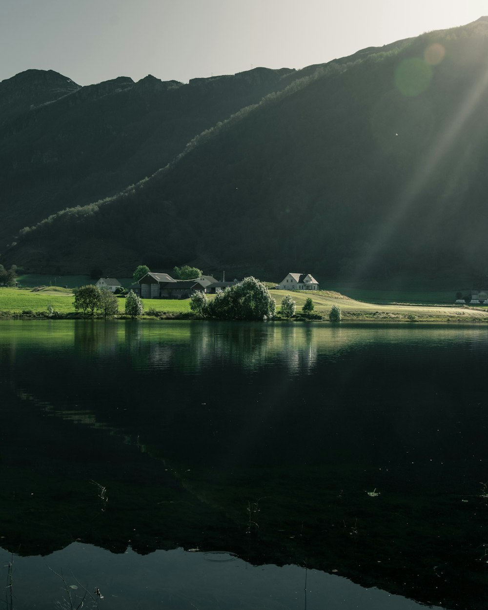 green mountain slope and lake scenery