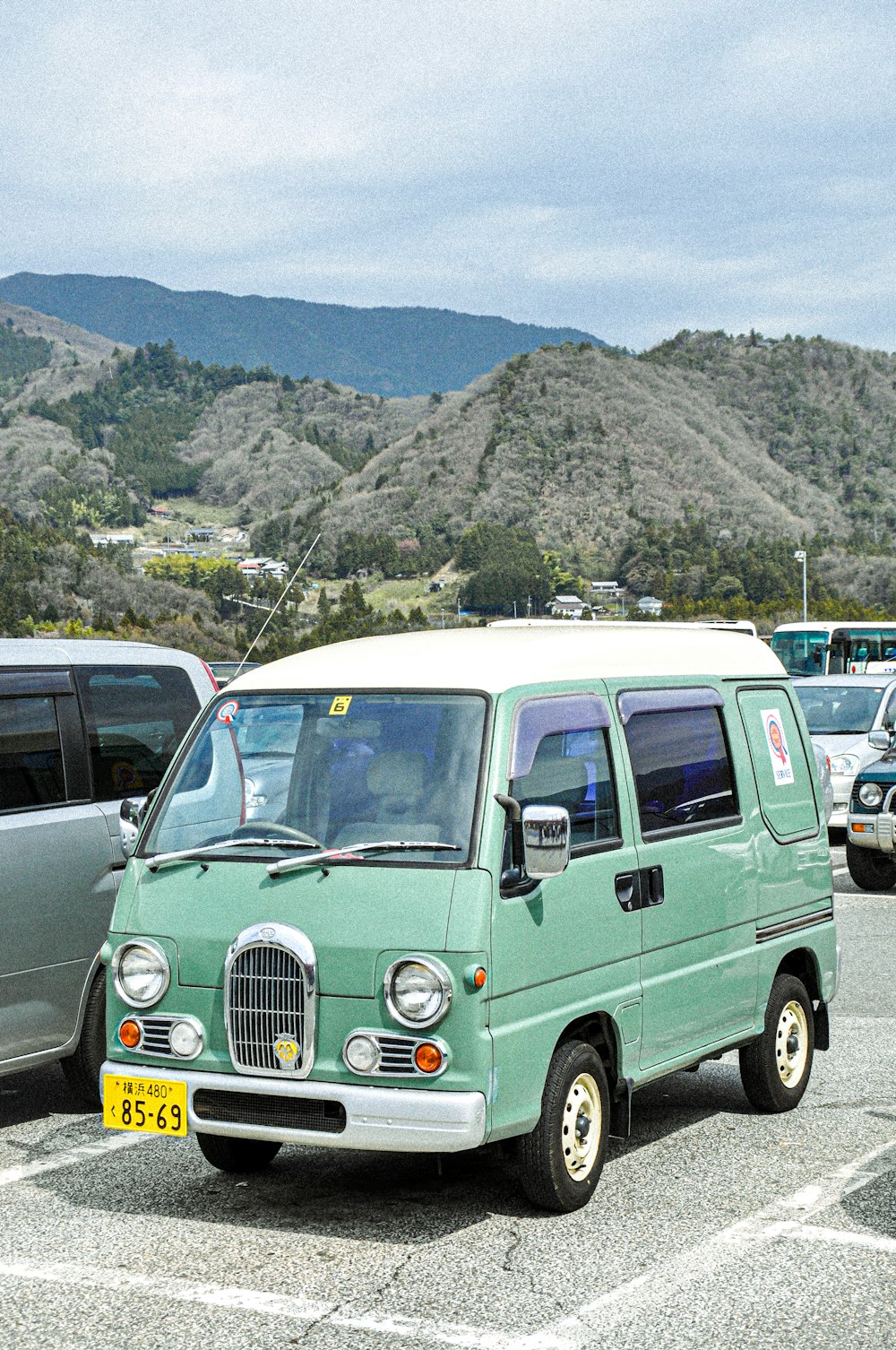 teal van parked on parking lot