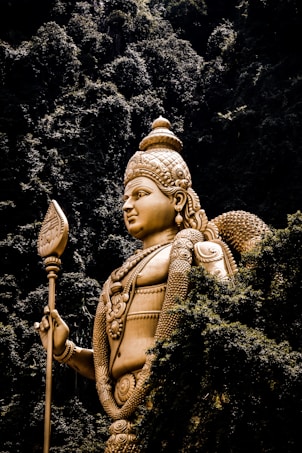 Buddha statue beside trees at daytime
