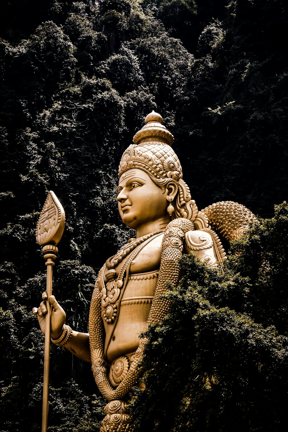 Buddha statue beside trees at daytime