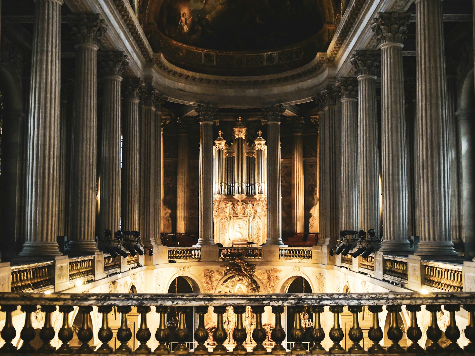 An elegant shot of a classical concert hall interior, bathed in warm light with intricate architectural details and a hint of sheet music overlay.