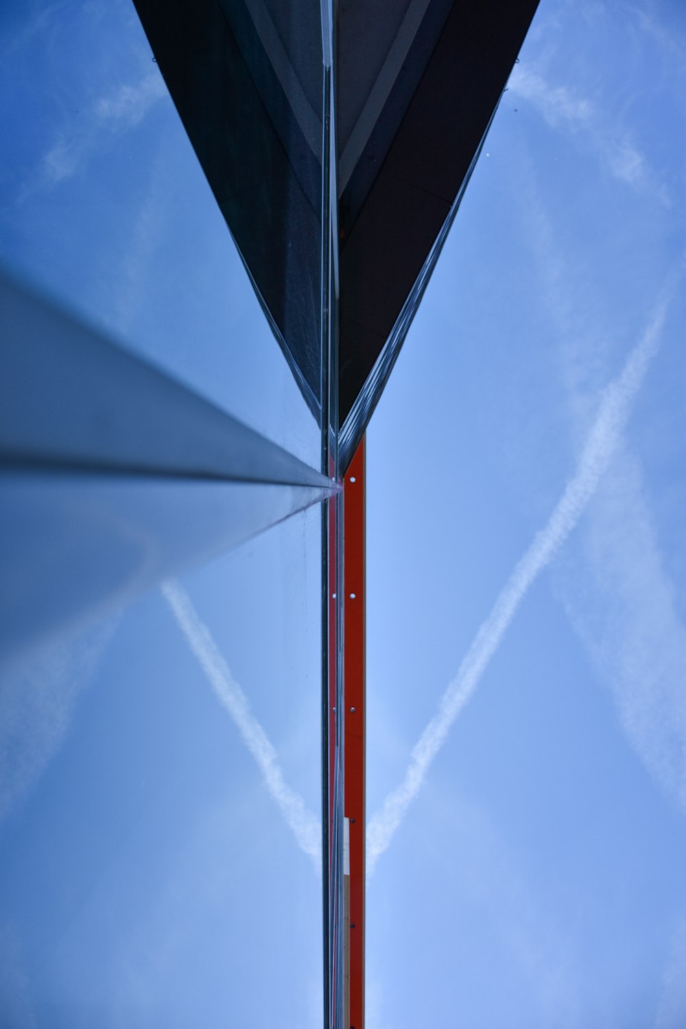 a red pole with a sky in the background