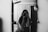 grayscale photo of woman holding camera