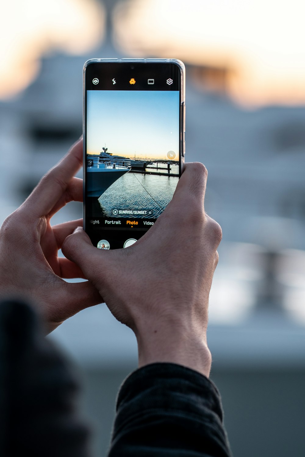 man taking photo of boat