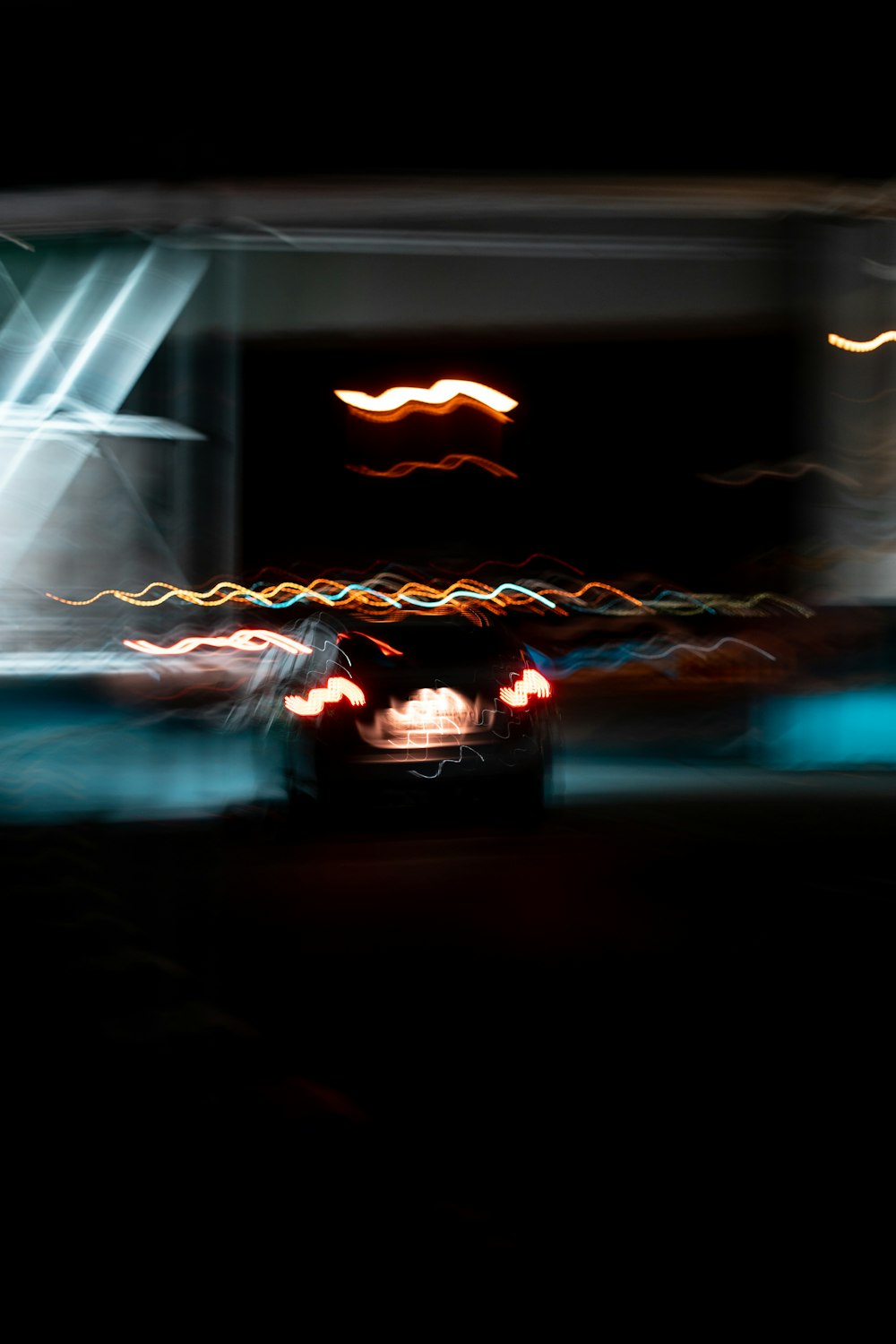 a car driving down a street at night