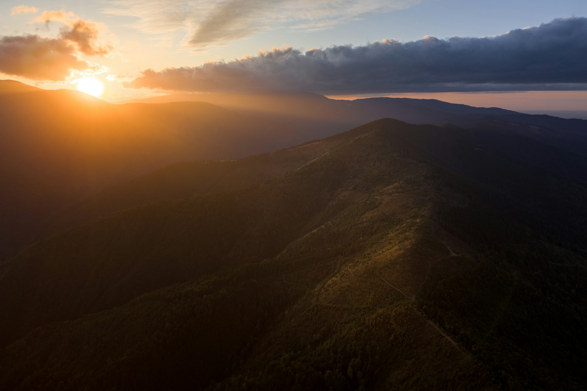 Behind-the-scenes shot of the film crew capturing a dramatic sunset over the valley where the story unfolds.