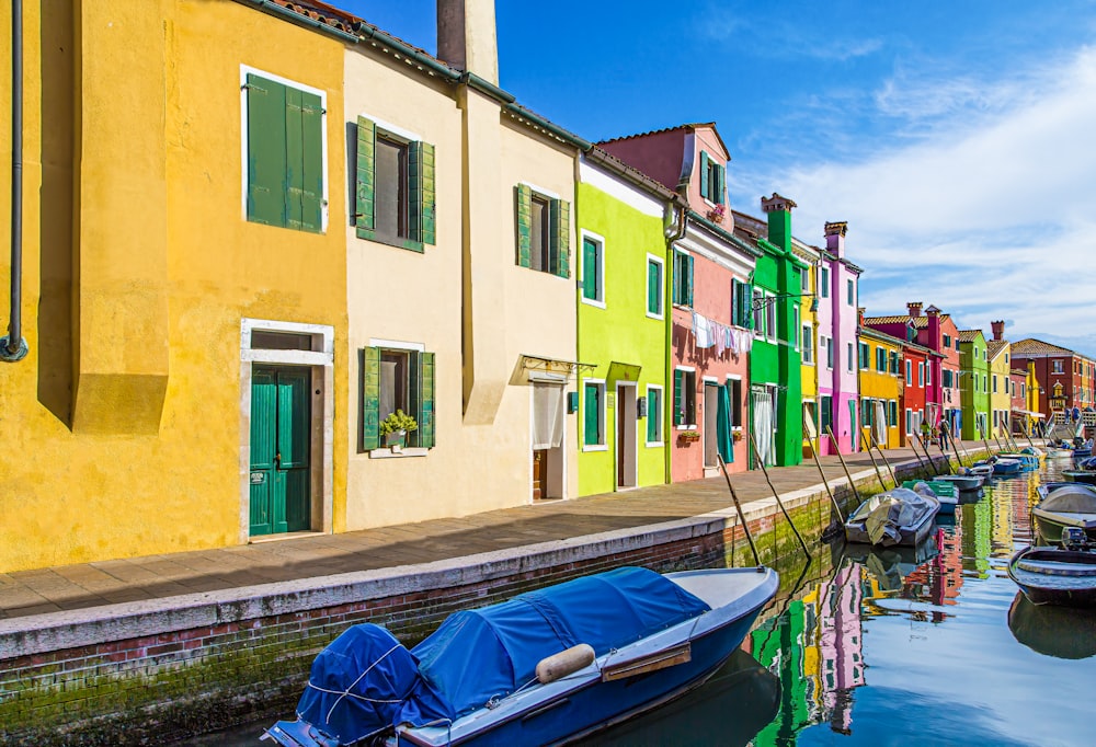 boats on river near multicolored houses