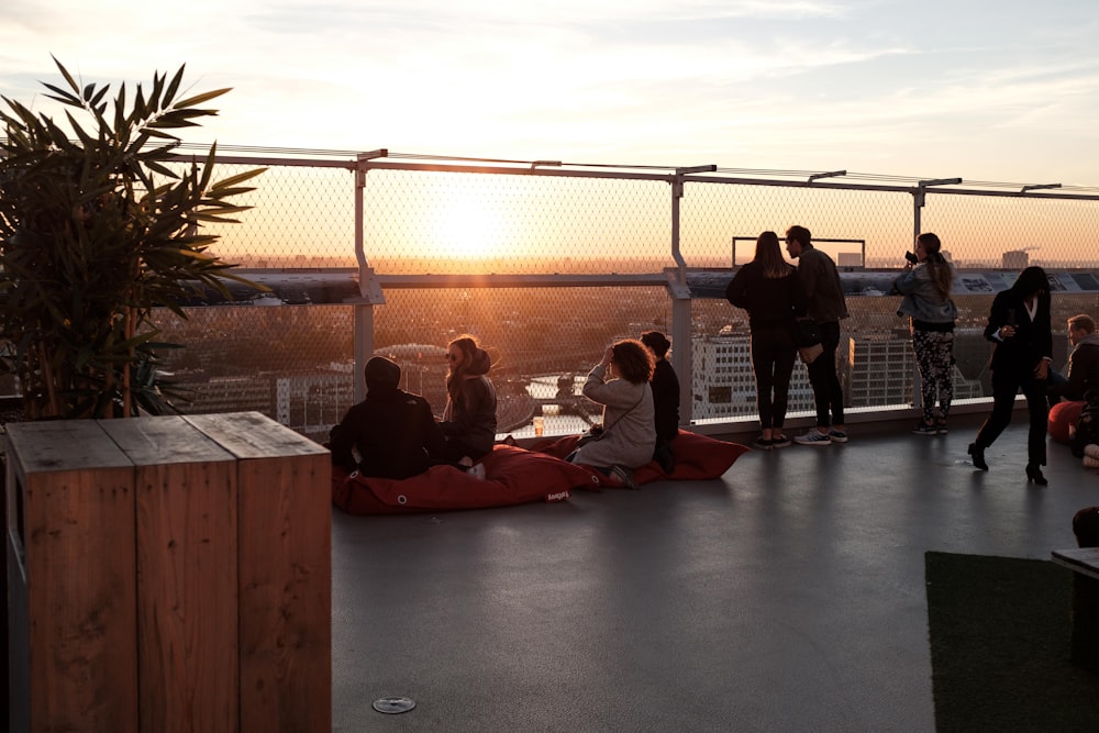 people gathering on rooftop during sunrise