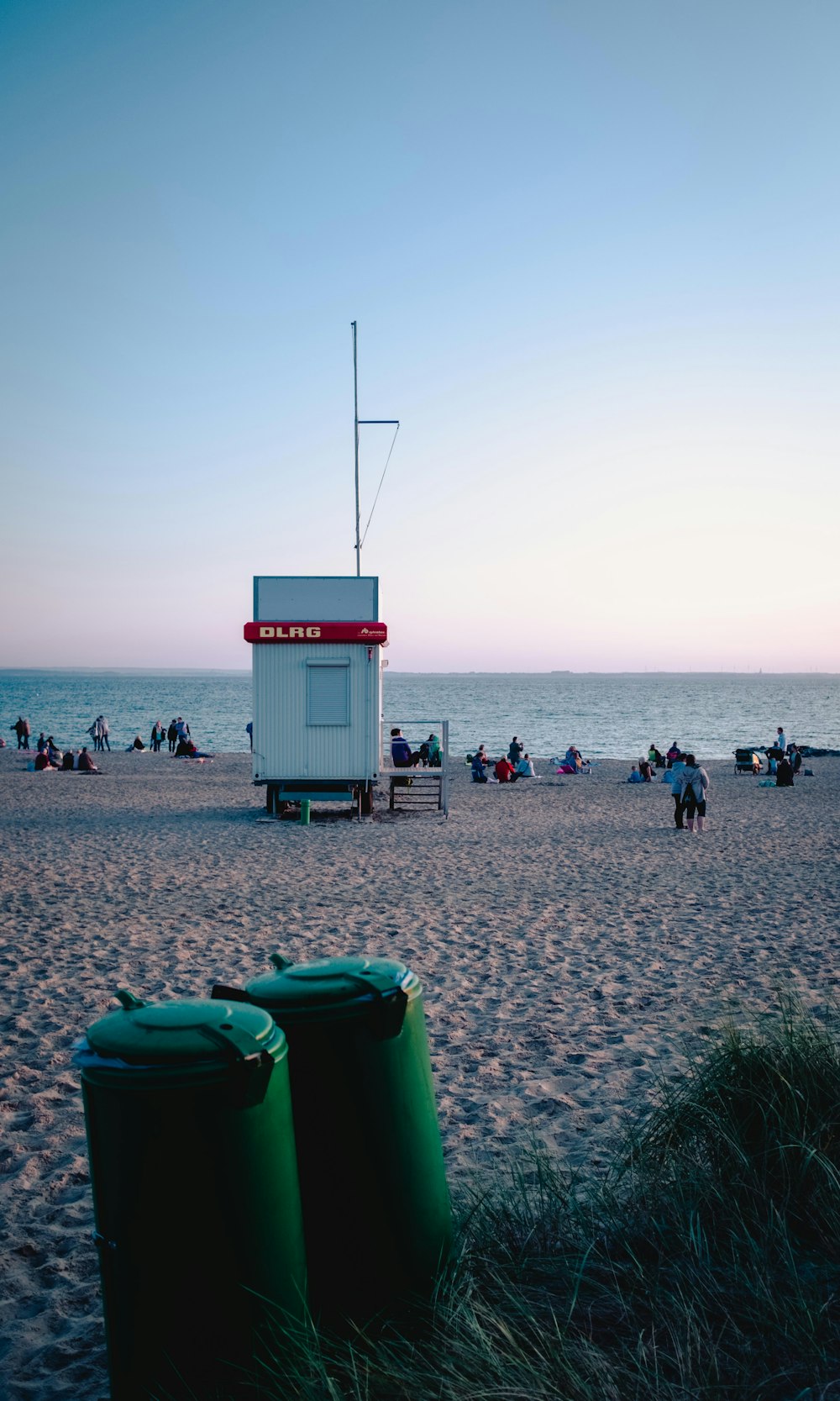 two green garbage bins