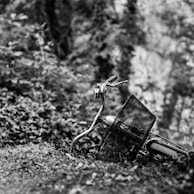 grayscale photography of bicycle on hill