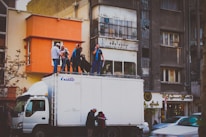 A film crew setting up equipment on a bustling city street.