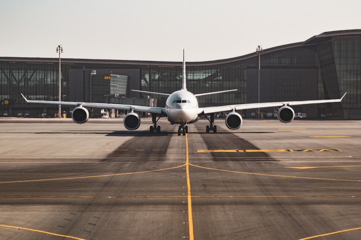 Traveller using self-service check-in kiosk at airport terminal. Photo by Uwe Hensel via Unsplash.