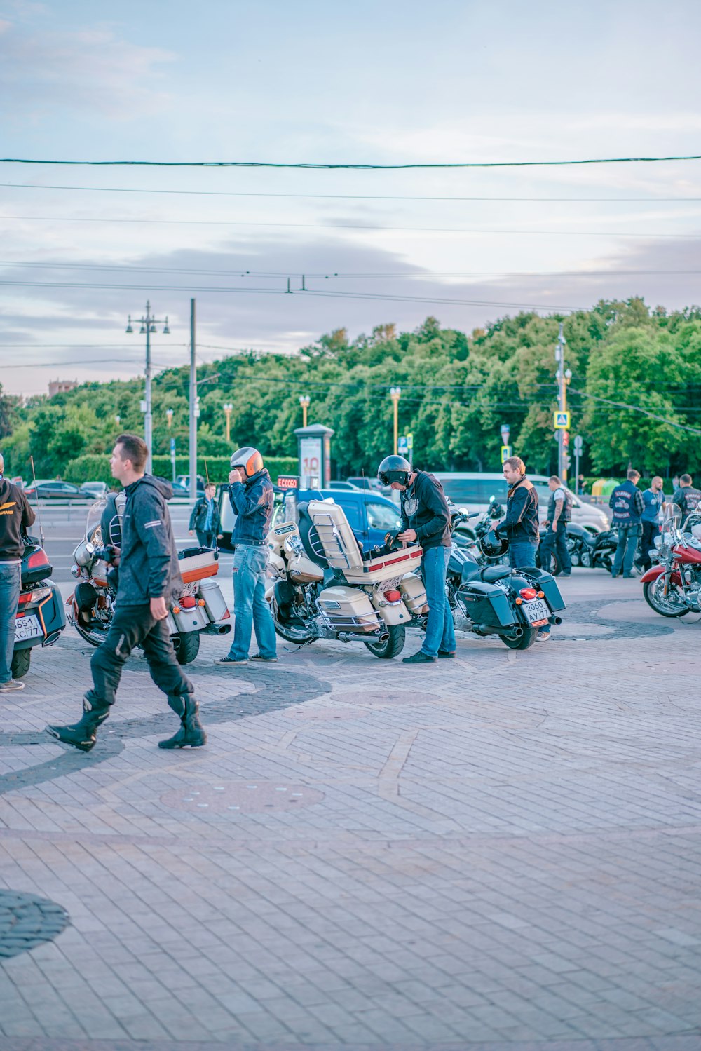 person standing beside motorcycle during daytime