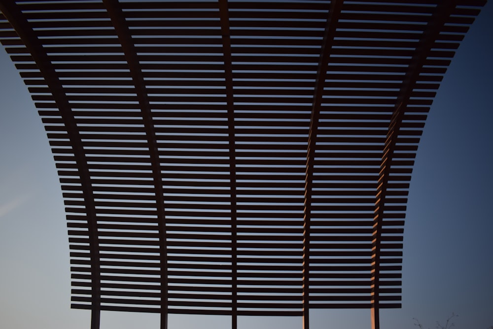 a close up of a metal structure with a sky in the background