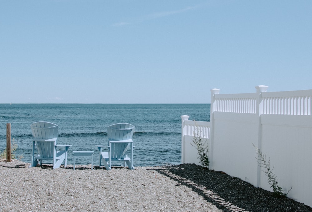 two Adirondack chairs in beach