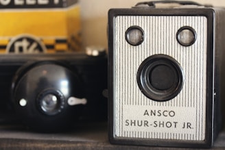 an old camera sitting on top of a shelf