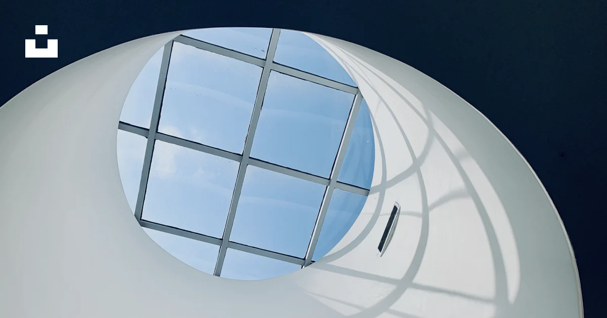 Round Blue Window A round window in the ceiling of a building photo – Free Blue Image on ...