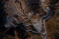 Close-up of a drone camera capturing aerial footage of a winding mountain road.