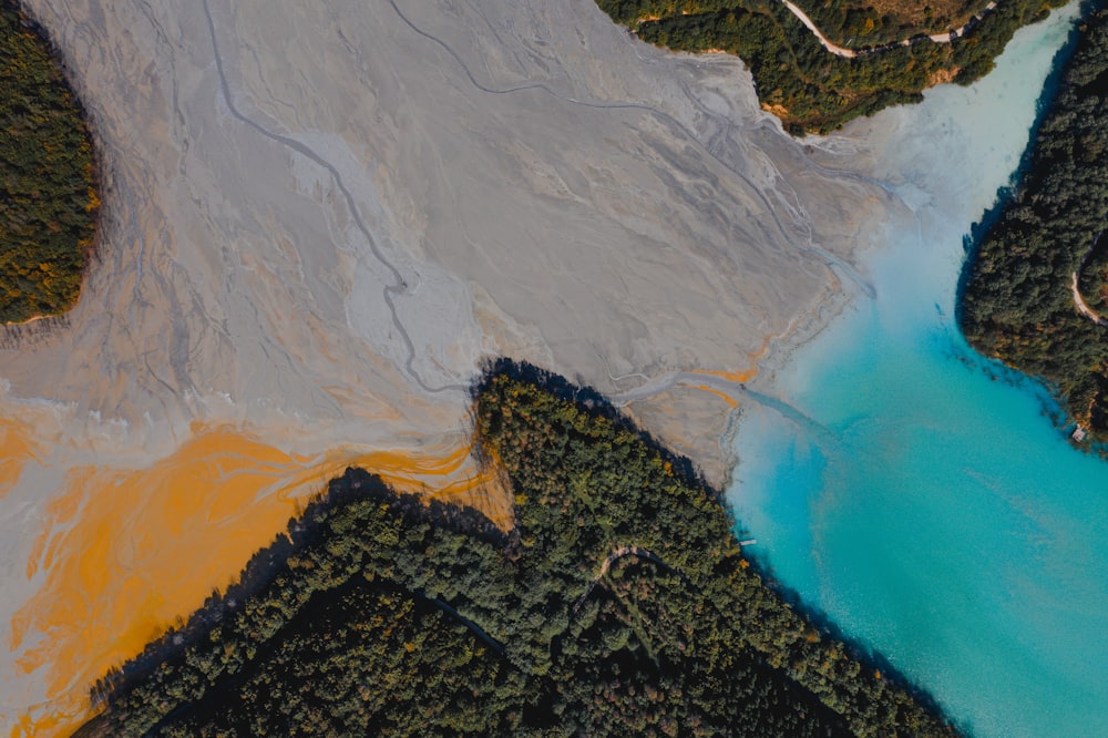 an aerial view of a blue lake surrounded by trees