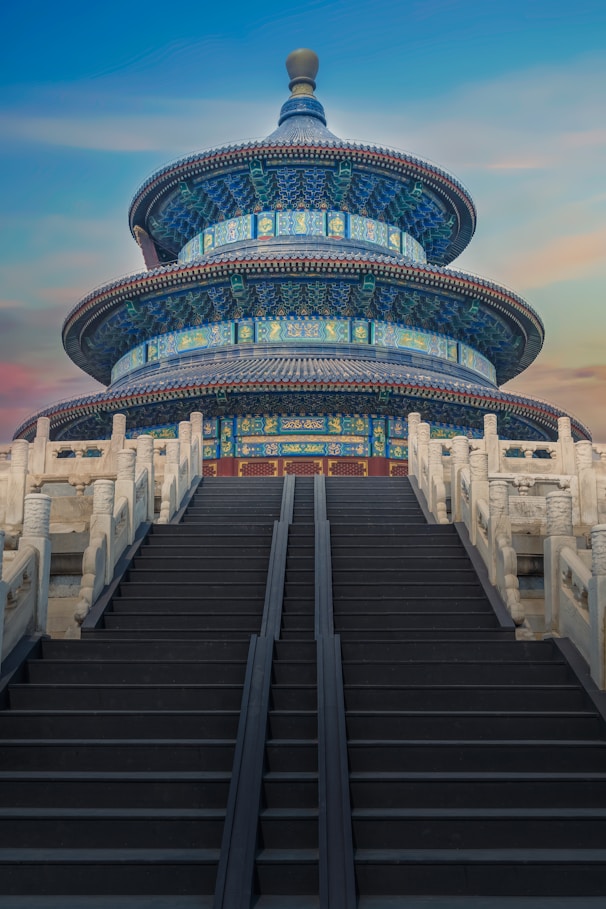 low-angle photography of blue 3-storey cone temple