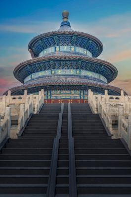 low-angle photography of blue 3-storey cone temple