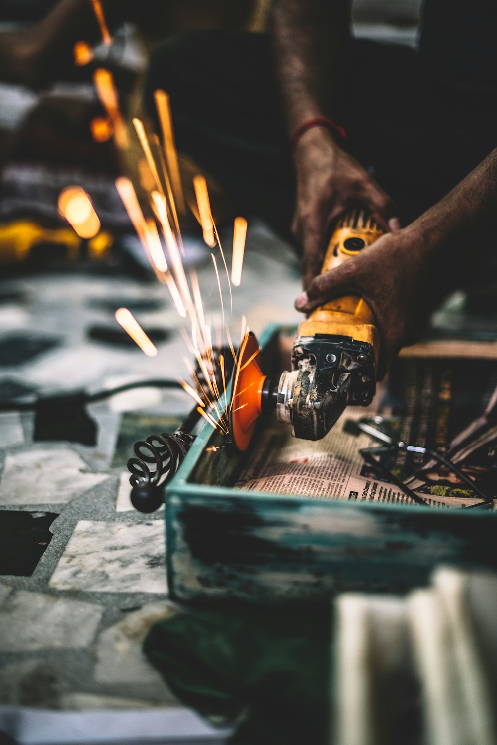 time lapse photography of man angle grinding steel