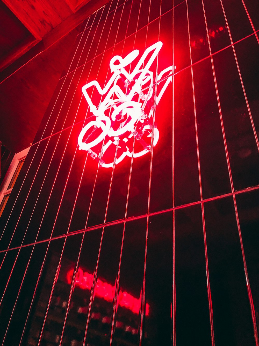 a red neon sign on the side of a building