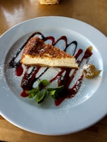 A beautifully plated slice of Oreo cheesecake with a dollop of whipped cream and mini Oreos as garnish.