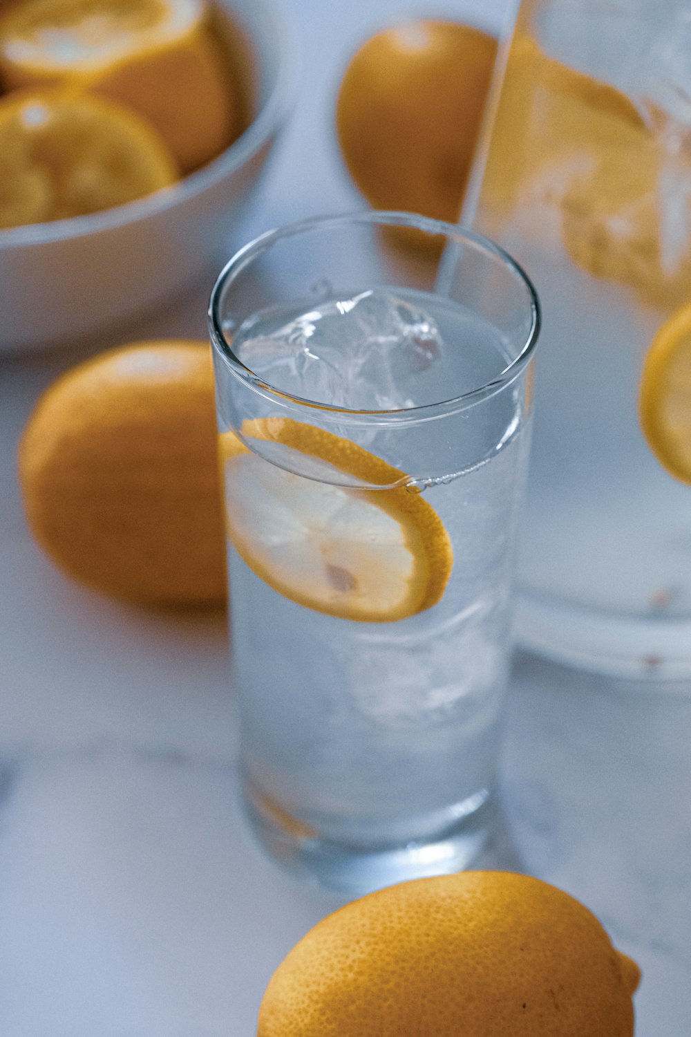 lemons near drinking glass