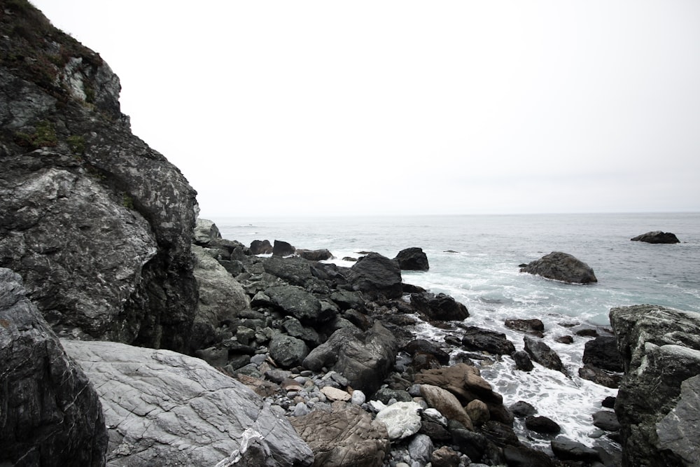 sea water hitting rocks forming bubbles