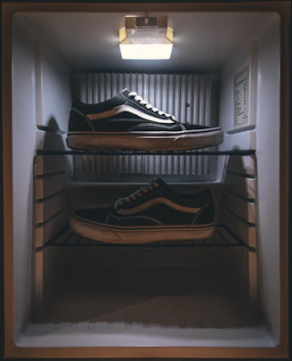 pair of black Vans low-top sneakers on rack