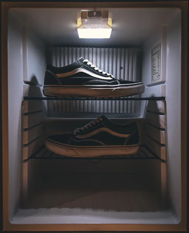 pair of black Vans low-top sneakers on rack