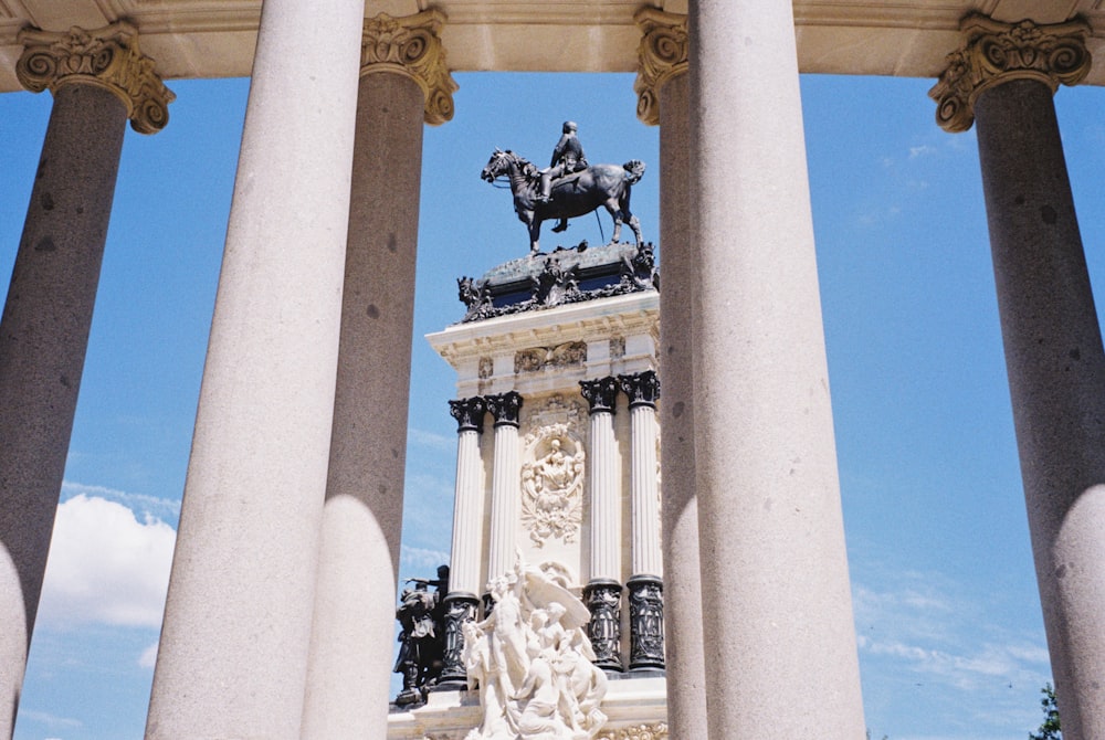 white concrete column across black statue