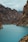 body of water under hills at daytime