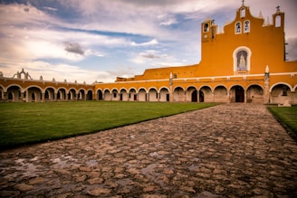 church near grass and pathway during day