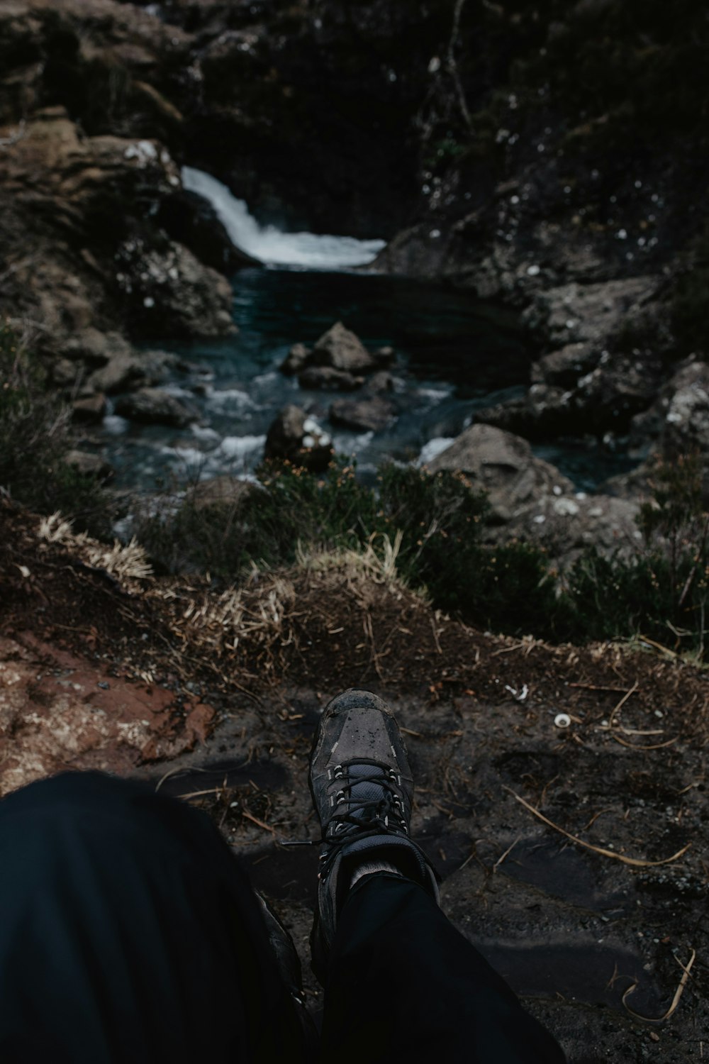 person wearing black pants and gray hiking shoes