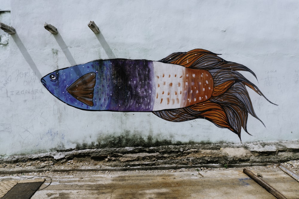 blue, purple, white, and orange fish wall art