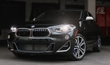 Sleek BMW parked in a high-end garage with ambient lighting.